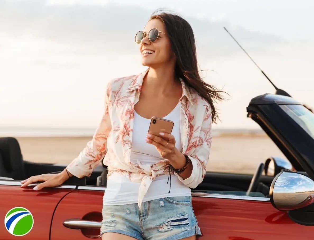 Woman smiling next to her car